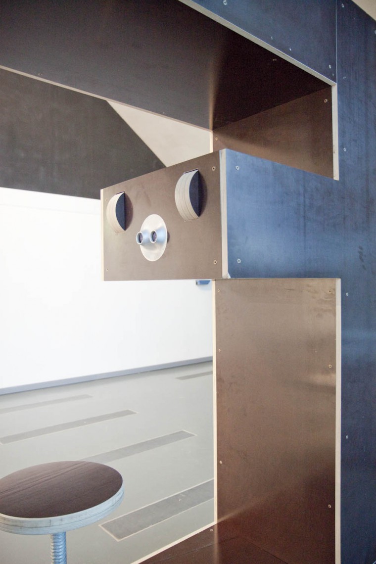 Les molettes de défilement qui permettent de passer d'une image à l'autre sont placées plus haut que des oculaires. Ainsi, les mains du visiteur forme une abat-jour qui le protègent des entrées de lumière latérale, gênantes pour le visionnement.